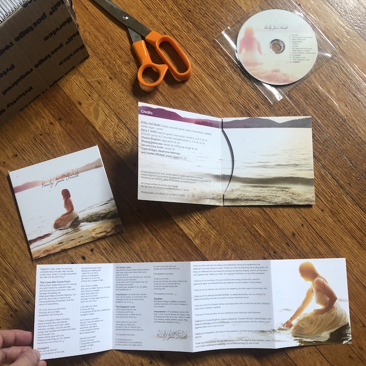CD, CD jacket, and liner notes spread on the floor for the album Awaken by Emily Joan Smith.